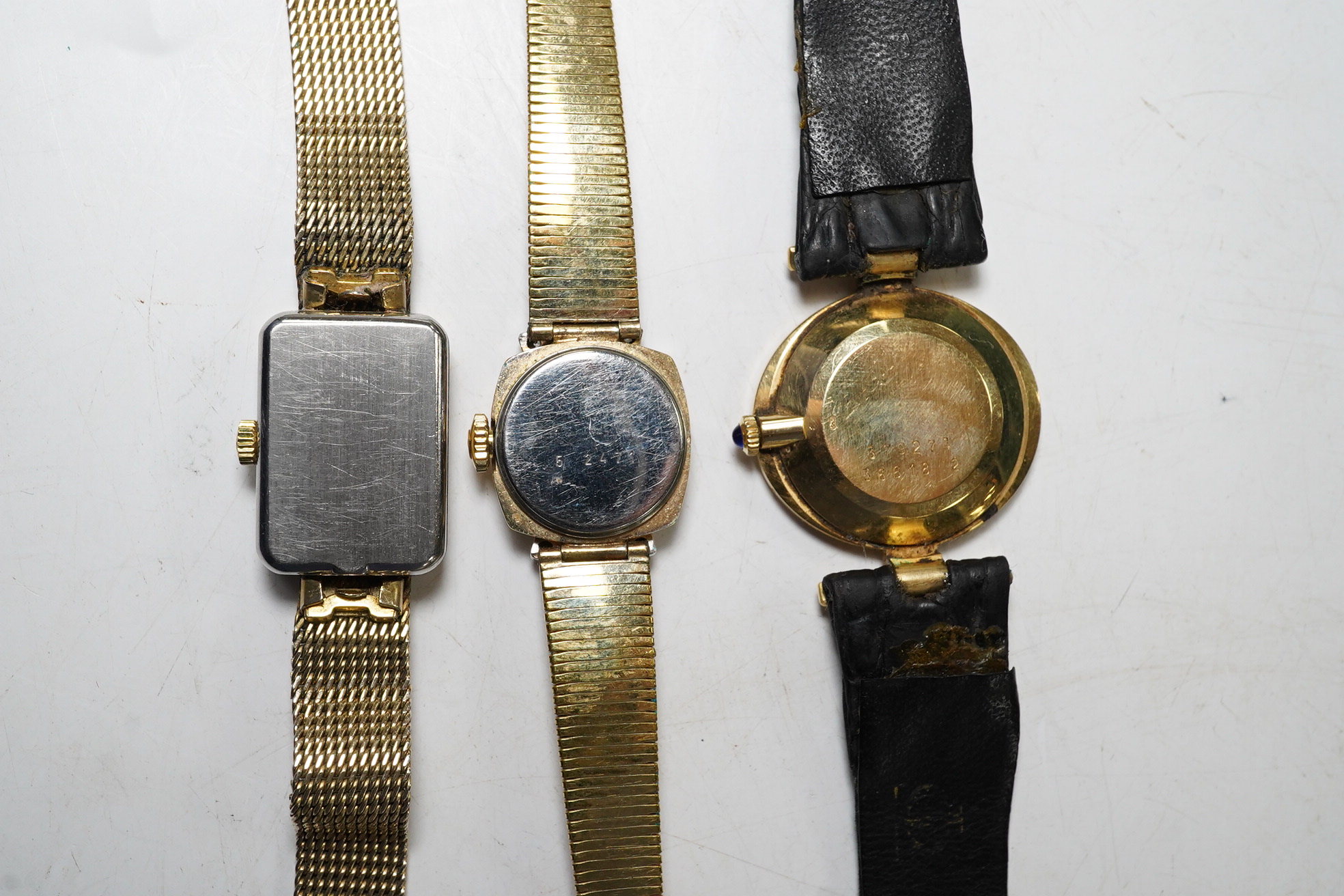 A ladies stylish Baume Mercier 18ct gold wrist watch, in original green leather case, and two gold plated wrist watches by Omega and Bucherer. Condition - Baume Mercier movement not going, later strap with gold plated bu